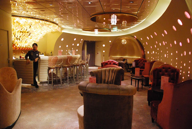 A waiter staffs an entertainment lounge bar aboard Disney Dream. 