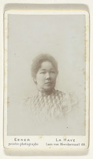 Studioportret van een aziatische vrouw in een jurk met hooggesloten kraag