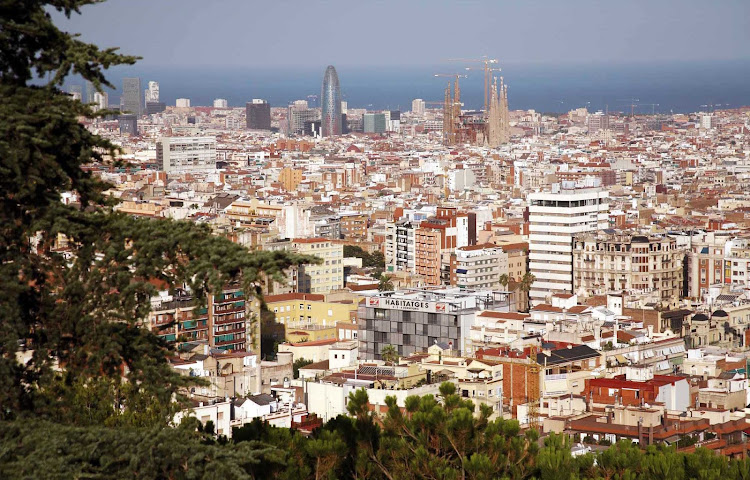 A sweeping view of the Barcelona skyline, with the unfinished Sagrada Família in the distance.