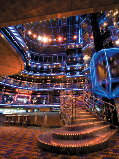 At night, Carnival Ecstasy's 6-story Grand Atrium glows with neon and bright lights.