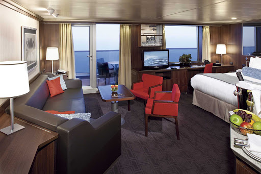 Holland-America-Signature-Class-Neptune-Suite-NA10-08832-1 - Neptune Suite, also called a Deluxe Veranda Suite, aboard Nieuw Amsterdam gets you 506 to 590 square feed including a private veranda, king bed (or two singles), bathroom with dual sink vanity, full-size whirlpool bath, sitting area with sofa, priority boarding for ports of call, priority dining and seating and special amenities. (Be sure to ask Cruiseable's travel specialists for details about the small differences between Neptune Suites and Signature Suites.)