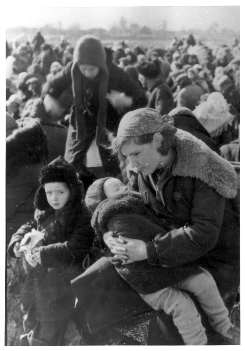Lubny, Ukraine, A mother with her two children awaiting, with other Jews from the town, at the assembly point, 16/10/1941