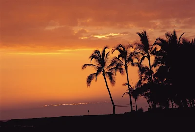 Kailua Bay on the windward coast of Oahu at twilight The remains of Ahuena Heiau, where sacrifices were offered to the gods in ancient times, are said to be found in the coconut grove in the foreground.