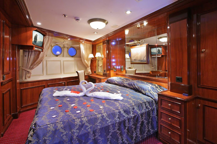 Relax during your voyage in a cabin with king-size bed and two windows on your Royal Clipper sailing.  