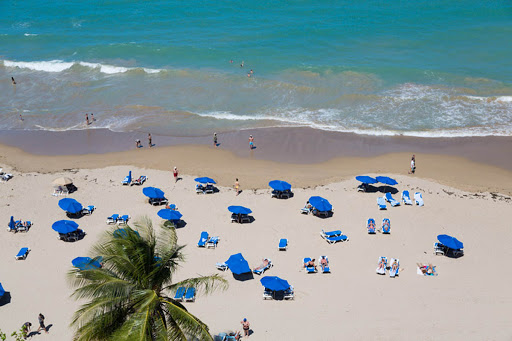 Visitors flock to Isla Verde Beach in Puerto Rico.