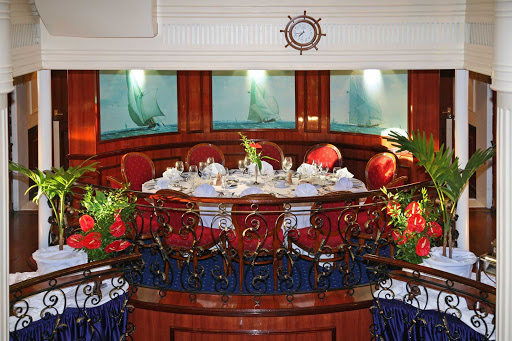 Enjoy a grand feast and meet new people in the main dining room aboard Royal Clipper.
