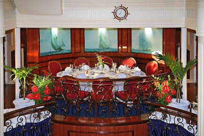 Enjoy a grand feast and meet new people in the main dining room aboard Royal Clipper.