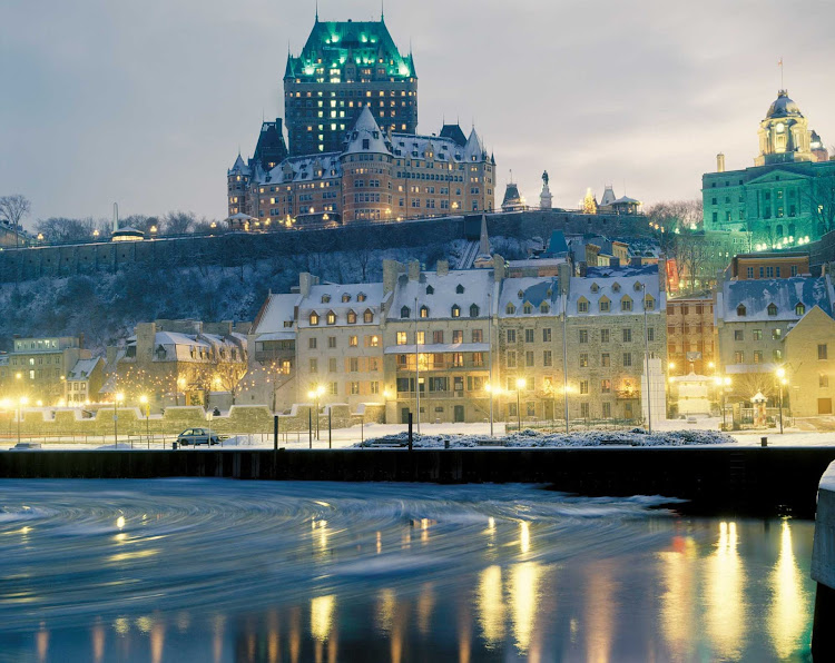 Chateau Frontenac, perched above the St. Lawrence River in Quebec City at dusk.