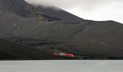 Deception Island, a bleak volcanic caldera, offers one of the safest harbors in Antarctica. It was once a whaling station, and it was said that the entire harbor was for years clogged with the carcasses of whales. A pair of volcanic explosions in the 1960s destroyed most of the man-made structures. Today, Argentina maintains a small but colorful base here.