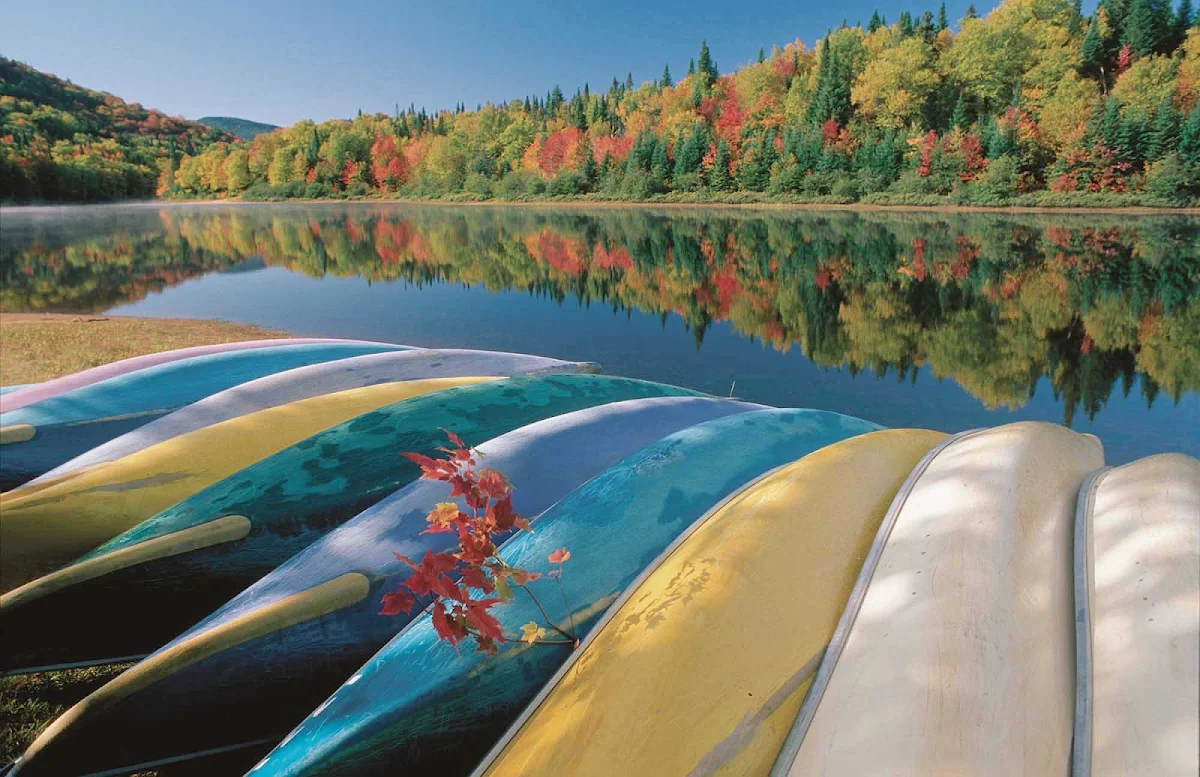 fall-foliage-canoes-Quebec - Fall is a lovely time to travel by foot or canoe in Jacques-Cartier National Park, Quebec, Canada.