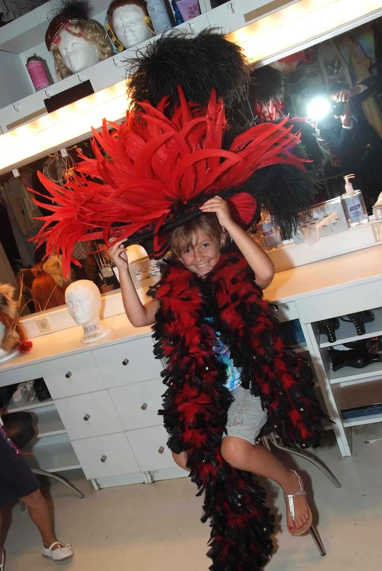 Kids get to explore back stage and play dress-up during Junior Cruisers activities on a Crystal cruise.