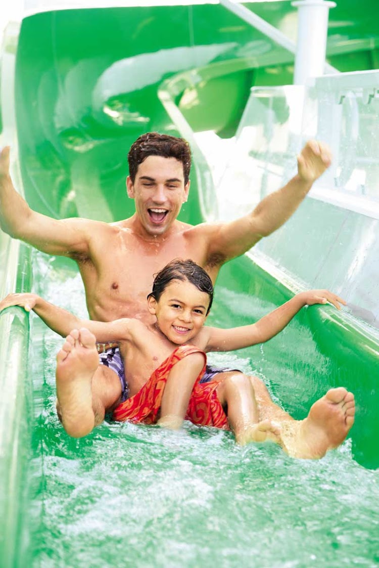 A dad and son take advantage of the Aqua Park slides aboard Norwegian Epic.