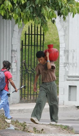 Cesar y Willian caminan para conseguir un poco de agua  cerca de la comunidad el Tanque, cerca de la Universidad de El Salvador. Foto de La Prensa, Nilton García