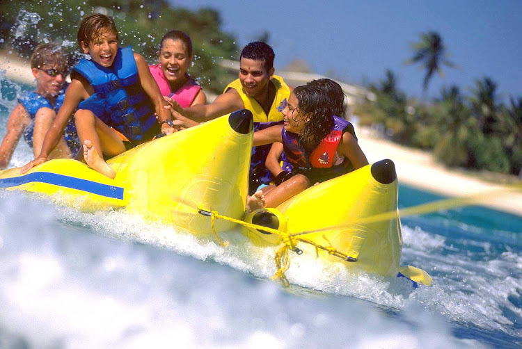 A family takes a raft ride on a banana boat on Aruba.