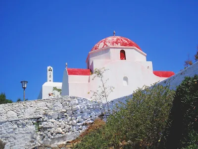 A Greek Orthodox Church sitting atop a hill on the Greek isle of Mykonos. 