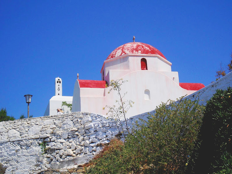 A Greek Orthodox Church sitting atop a hill on the Greek isle of Mykonos. 