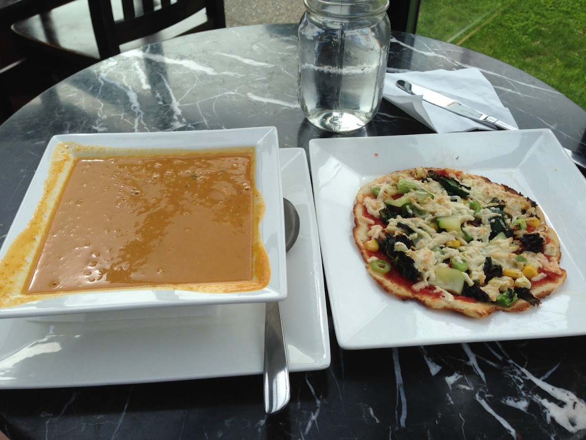 Bowl of Pumpkin and Black Bean Soup and Flatbread with Vegetables and Dayia Cheese.