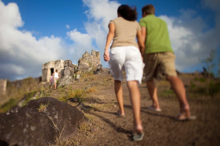Visitors explore hilltop ruins on St. Maarten.