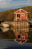 Fishing shed and it's reflection. by Julie Canuel -  